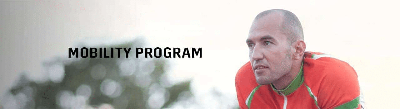 Male athlete in athletic wear focusing on a mobility program, with a blurred outdoor background and the text "Mobility Program" prominently displayed.