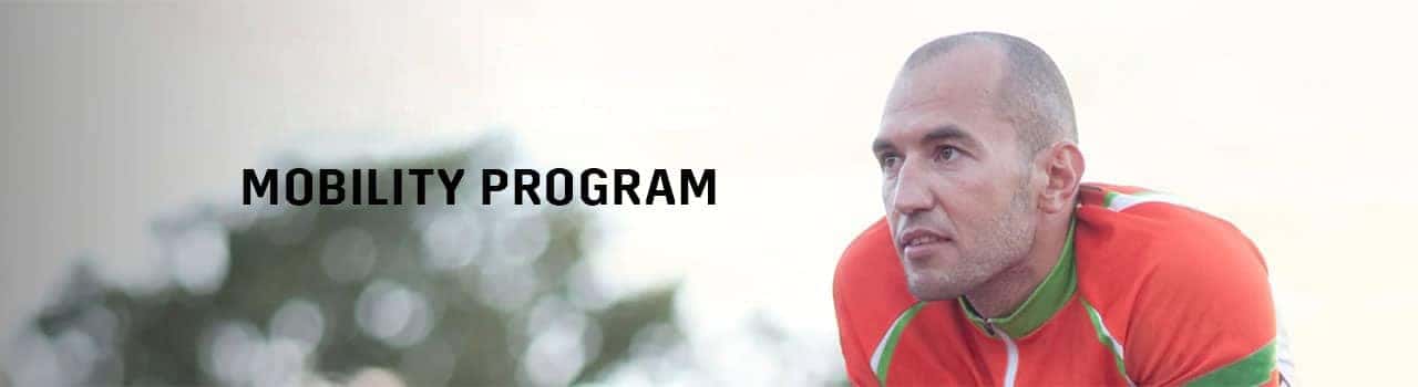 Athlete in a vibrant cycling outfit focused on enhancing mobility, promoting fitness and well-being through a dedicated mobility program.