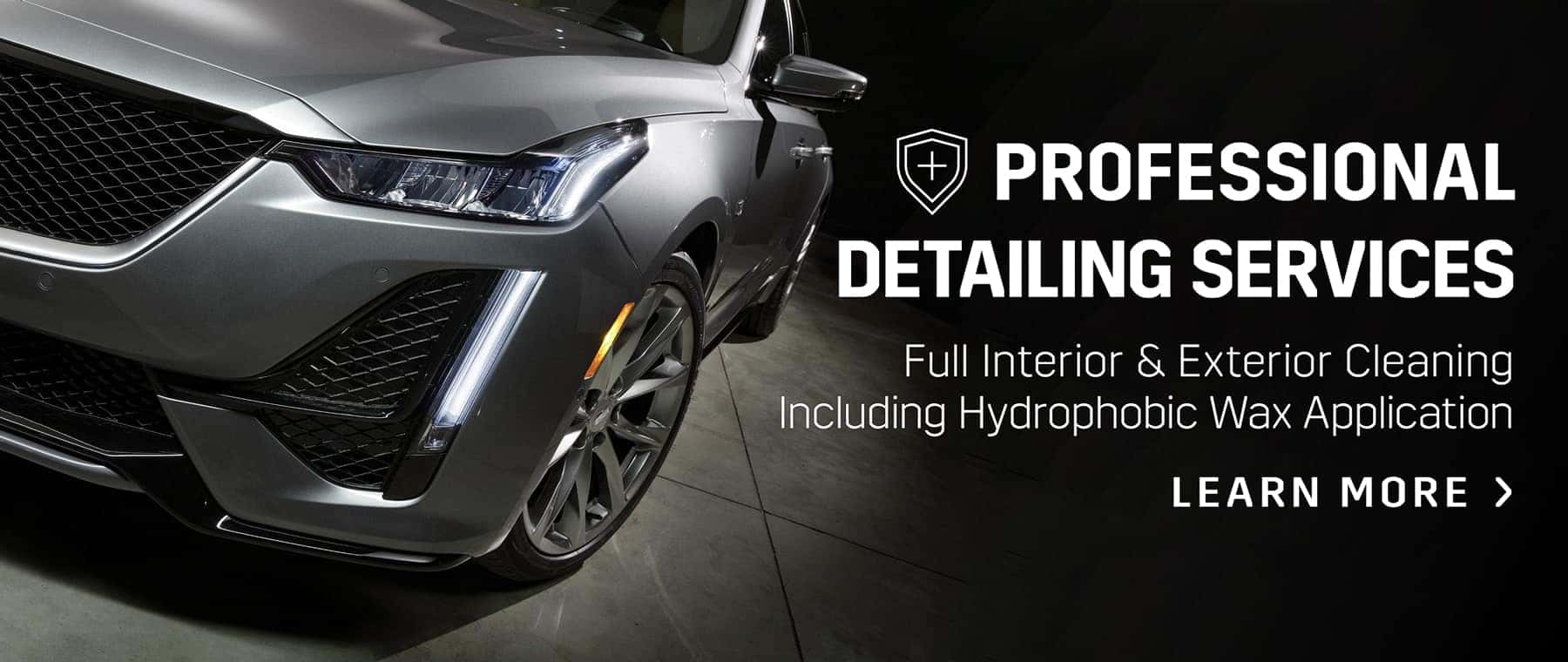 Close-up of a luxury car's front end showcasing professional detailing services, including full interior and exterior cleaning with hydrophobic wax application.
